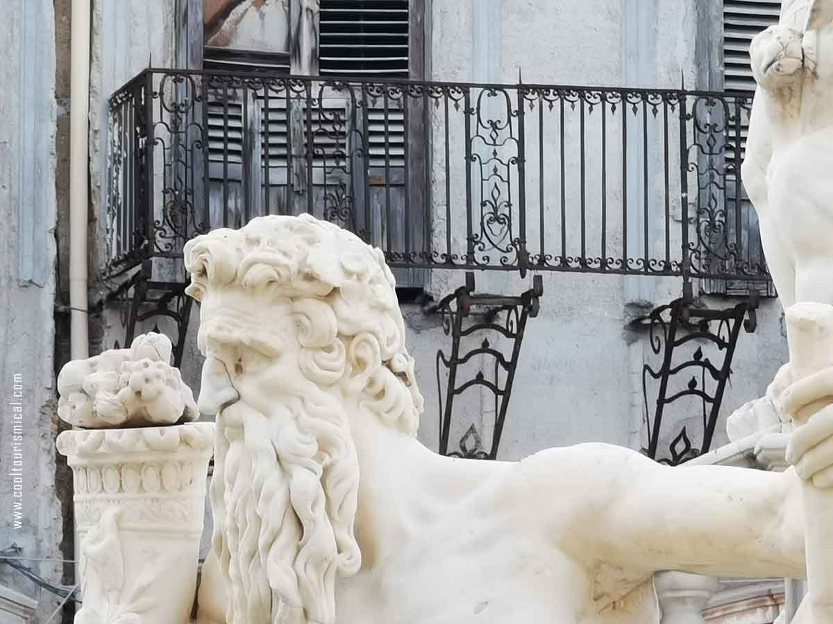 Fontana Pretoria in Palermo Sicily: a white statue against a grey backdrop